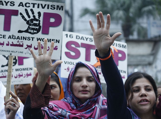 LAHORE, PUNJAB, PAKISTAN - 2015/12/10: Pakistani activists of women workers hold placards and shout slogans during a protest marked as