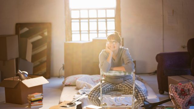 Woman unpacking boxes in attic