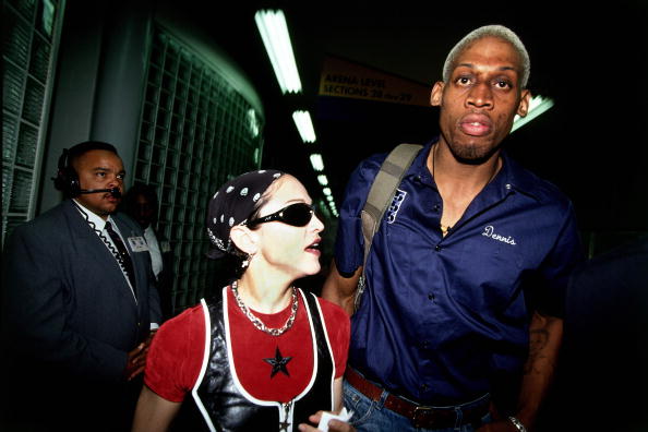 LOS ANGELES - APRIL 24 1994:  Dennis Rodman #10 of the San Antonio Spurs is seen leaving the arena with Madonna after playing an NBA game against the Los Angeles Clippers at The Los Angeles Sports Arena on April 24, 1994 in Los Angeles, California.  The Spurs defeated the Clippers 112-97.  NOTE TO USER: User expressly acknowledges and agrees that, by downloading and/or using this Photograph, user is consenting to the terms and conditions of the Getty Images License Agreement.  Mandatory Copyright Notice: Copyright 2004 NBAE (Photo by Andrew D. Bernstein/NBAE via Getty Images)