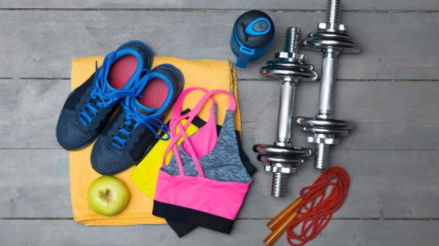 top view of colorful fitness equipment on wooden floor