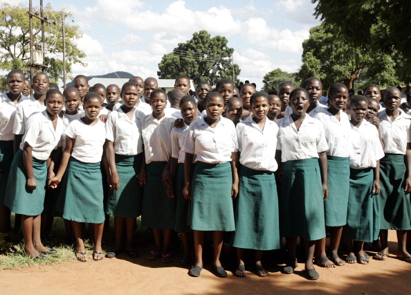 Secondary School girls wait for the arrival for a visit of US Pop Star Madonna at Home of Hope Children's Home, in Mchinji District is pictured April 3, 2013. Madonna, said to be the single largest international philanthropic donor to Malawi, also supports childcare in the country which is home to nearly a million children orphaned by AIDS. She arrived in Malawi on March 31 with the two children she adopted from the small landlocked African country. AFP PHOTO / AMOS GUMULIRA (Photo credit should read AMOS GUMULIRA/AFP/Getty Images)