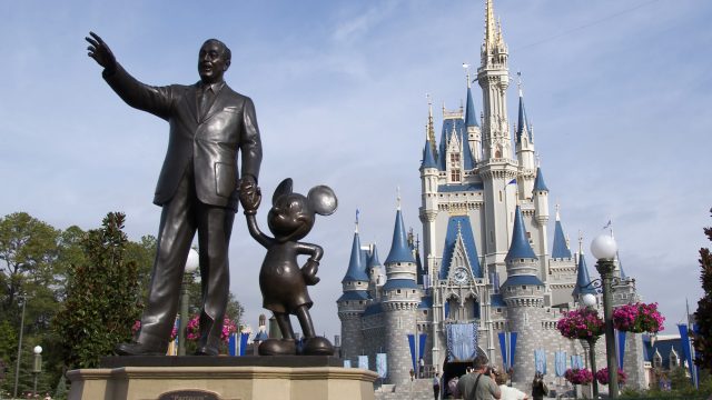 A statue of Walt Disney and Mickey Mouse stands in front of