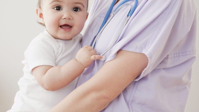 Nurse holding mixed race baby girl