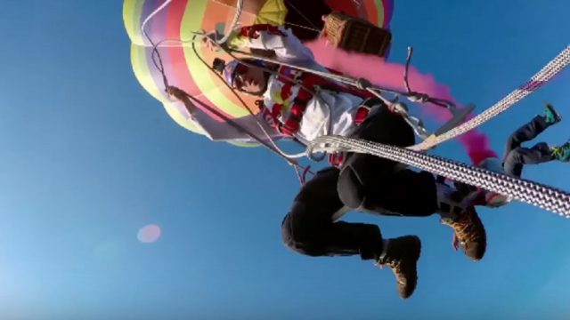 skydivers swing from hot air balloon