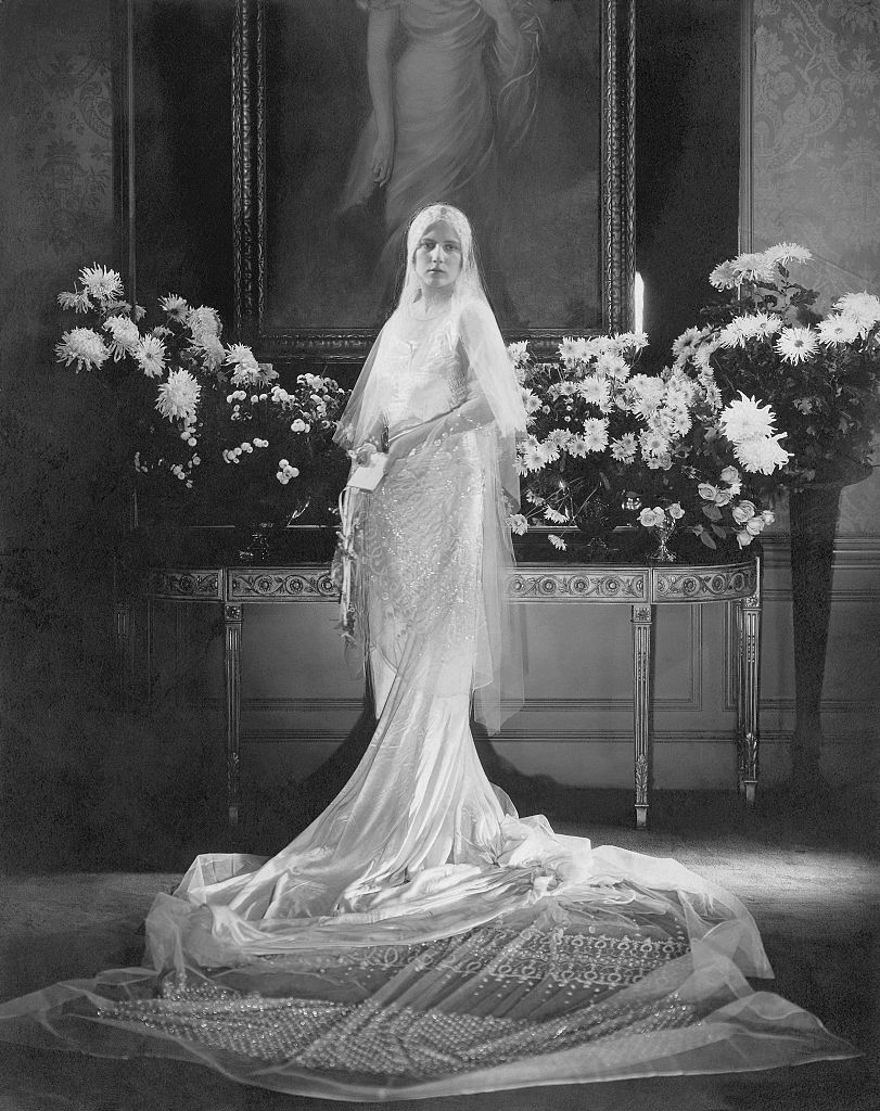 Mrs. Charles Coudert Nast (nee Charlotte Babcock Brown) (Conde Nast's daughter-in-law) wearing wedding dress with very long train and tulle veil swirled on floor before her. (Photo by Edward Steichen/Condé Nast via Getty Images)