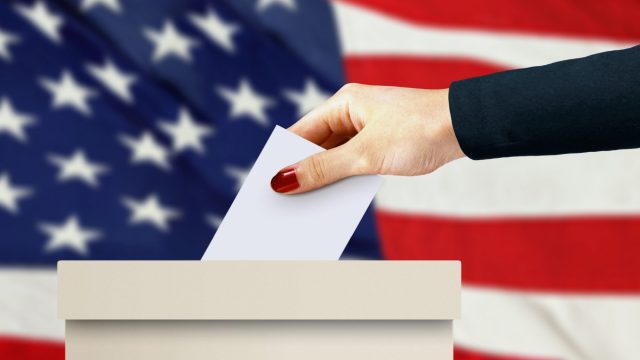 women hand casting a vote