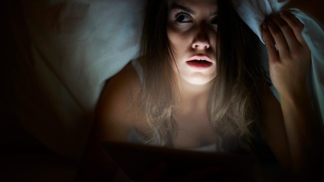 She watching scary movie being alone at home