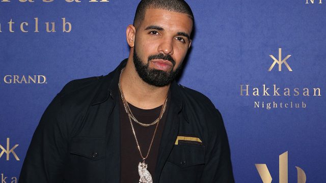 Drake wearing black jacket and owl ovo chain