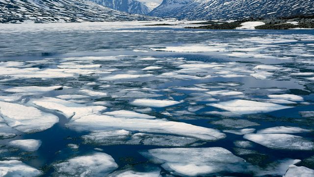 Geiranger Fjord - Spring, melting ice, snowy mountains behind