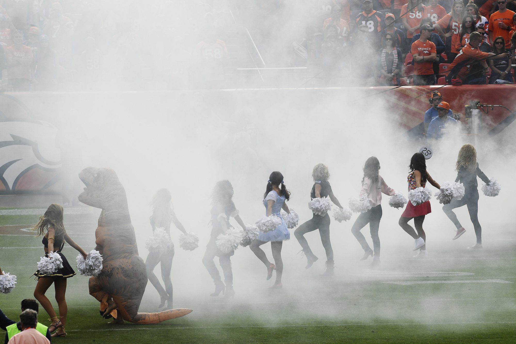 Broncos cheerleader performs in T-rex costume