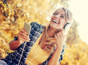 Young woman listening to music on smart phone