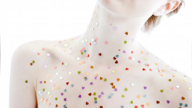 Colored Confetti Hearts on Woman's Chest and Neck