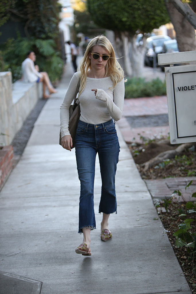 Emma Roberts wears checkered pants and black tee as she steps out