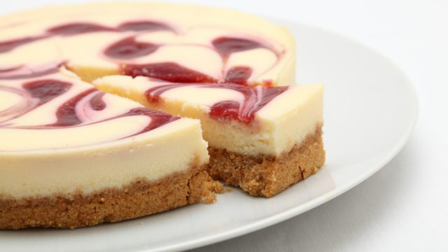 Raspberry cheesecake on a round white plate