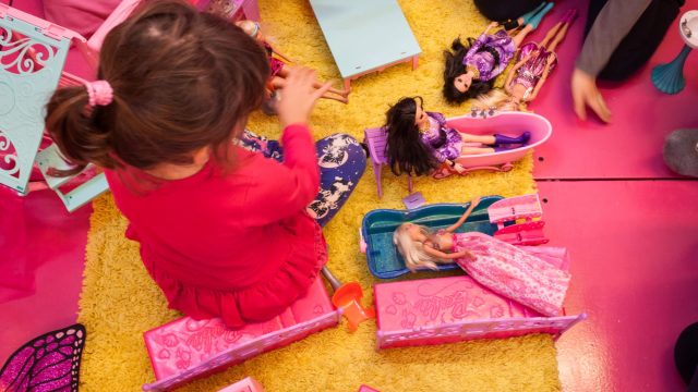 girl playing with dolls