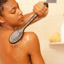 Woman brushing back in shower