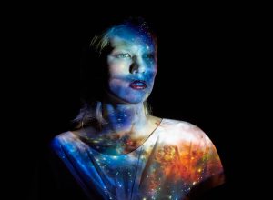 Young Woman with the Universe Projected on to Her