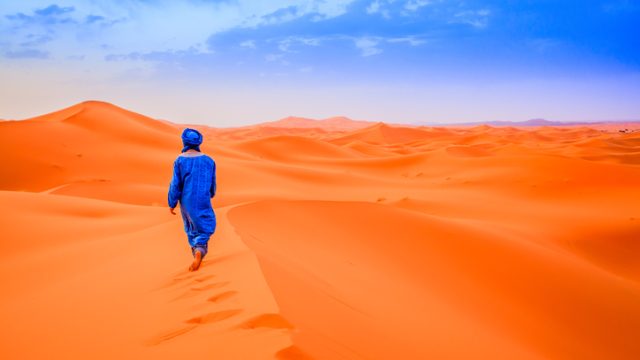 A Berber walking in the desert