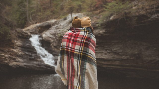 friends wrapped under blanket