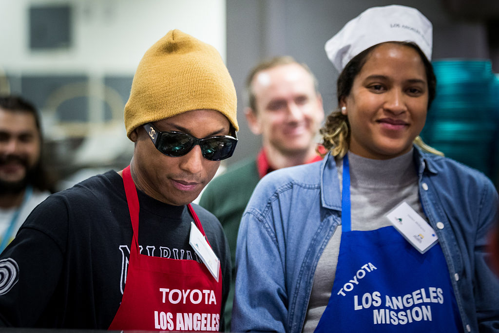 Pharrell Williams and his wife Helen Lasichanh attend the NBA