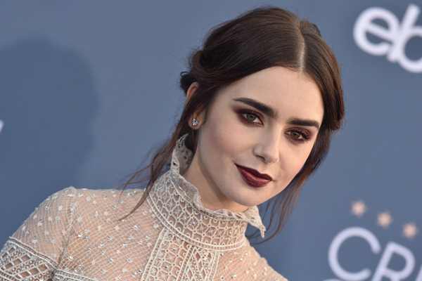Actress Lily Collins attended the Chanel Haute Couture 2014/2015 fashion  show wearing three H.Stern Stars rings in 18K Noble Gold with diamonds.