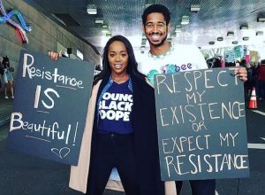 Aja Naomi King and Alfred Enoch at a Women's March