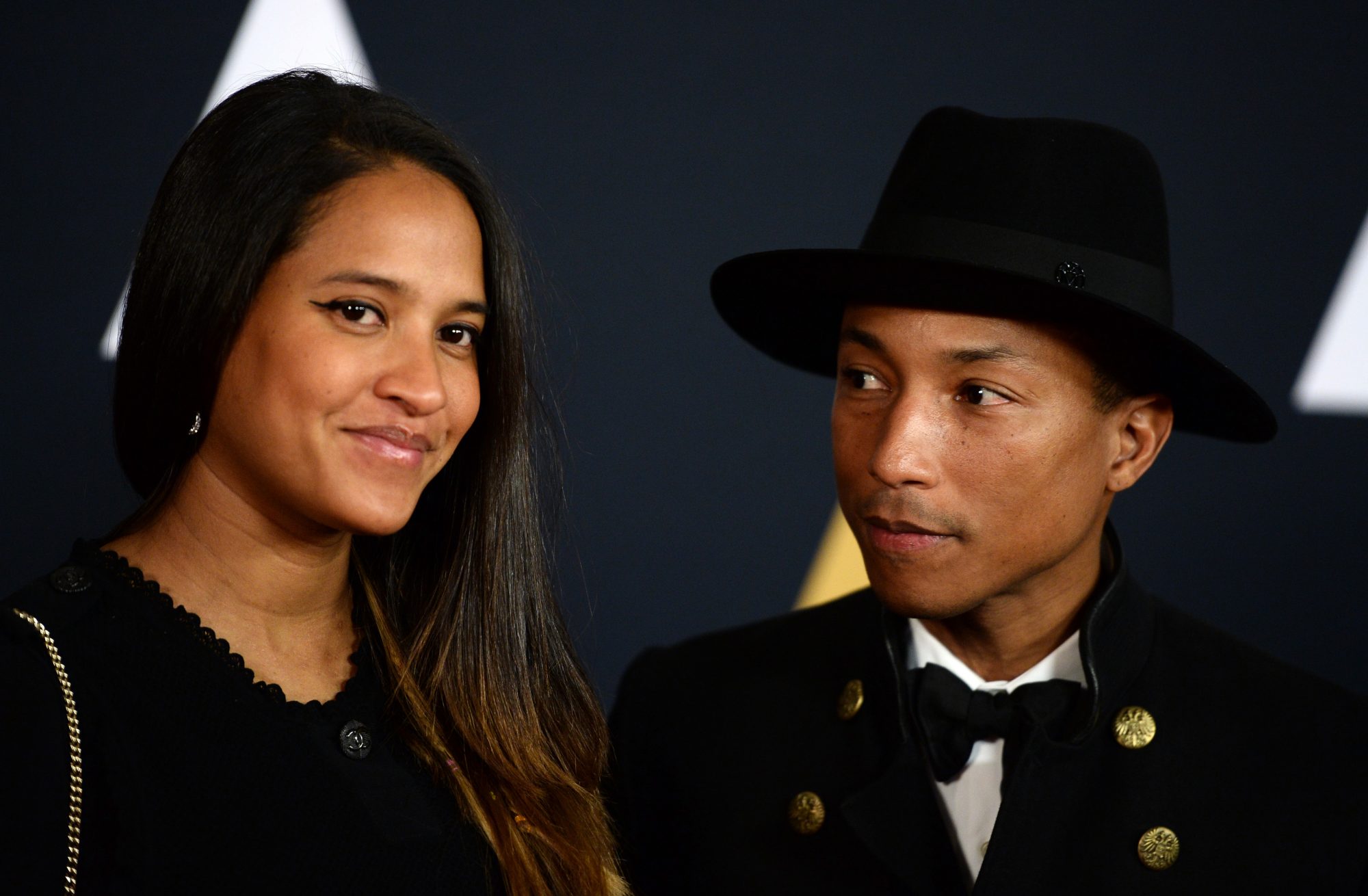 Pharrell Williams and Helen Lasichanh arriving to the Chanel show