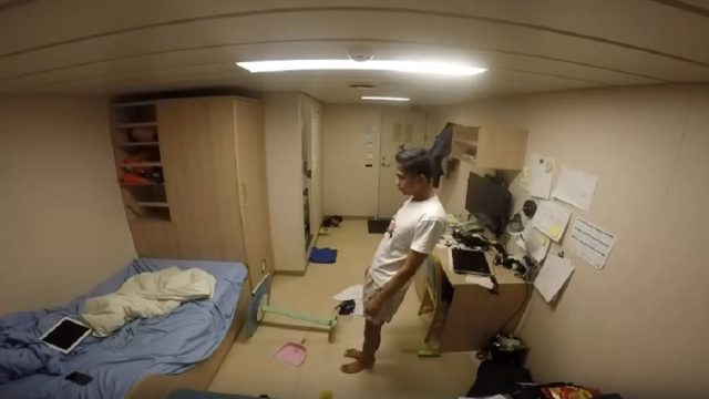 guy sways inside ship cabin during storm