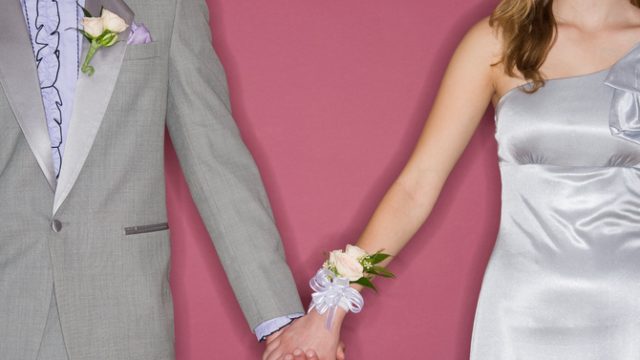 Couple in prom attire holding hands