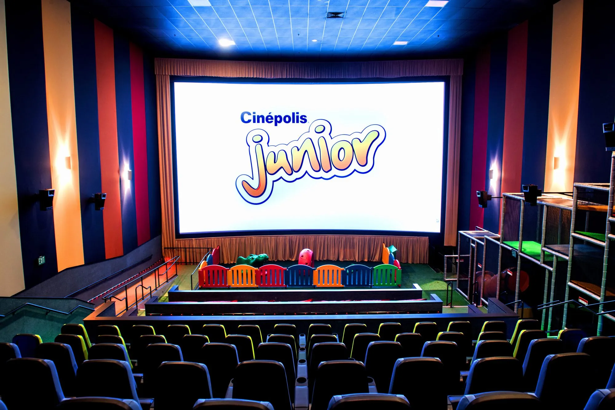 This movie theater has a jungle gym inside for kids which is a genius