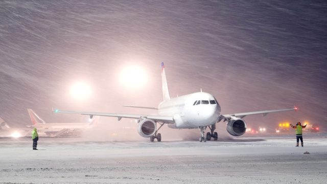 plane parked at the airport in winter