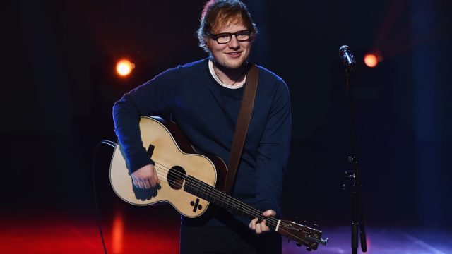 ed sheeran performs guitar blue sweater