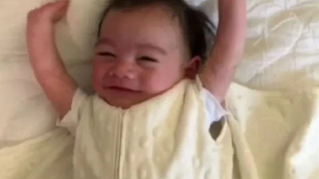 baby throws hands in the air