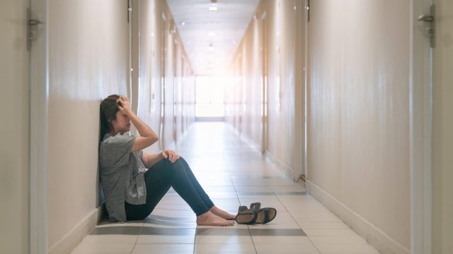 sad woman sitting in hallway