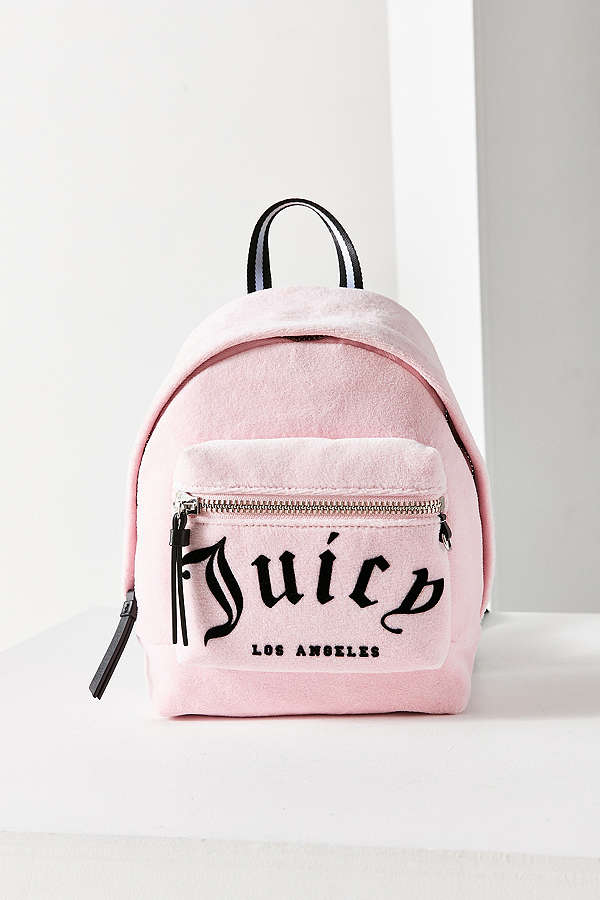 A teen with her Juicy Couture backpack on a street in New York on