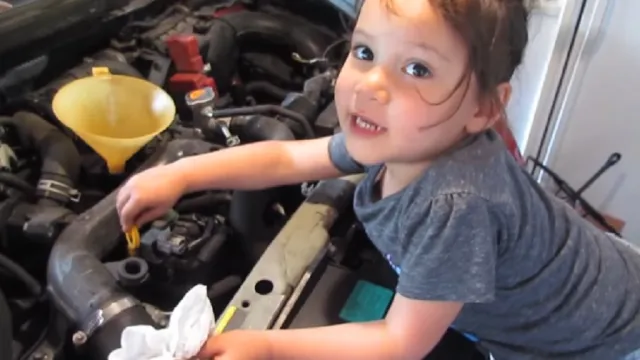 little girl does oil change