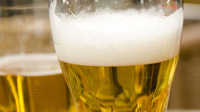 Close-up of half-filled beer glasses on restaurant table