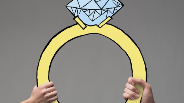 Two hands holding up a large illustrated engagement ring