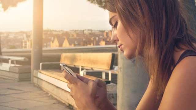 Young woman looking at her phone