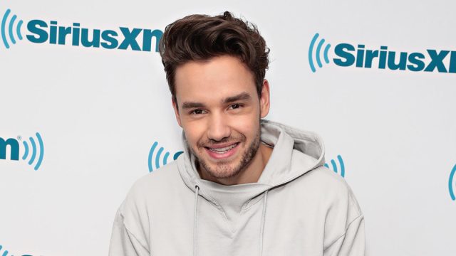 Liam Payne in a white hoodie.