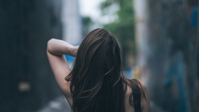 Back of woman's head with long dark hair