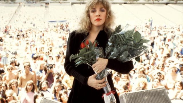 Photo of Stevie NICKS and FLEETWOOD MAC; Stevie Nicks posed onstage with roses at Rock N' Run benefit at UCLA