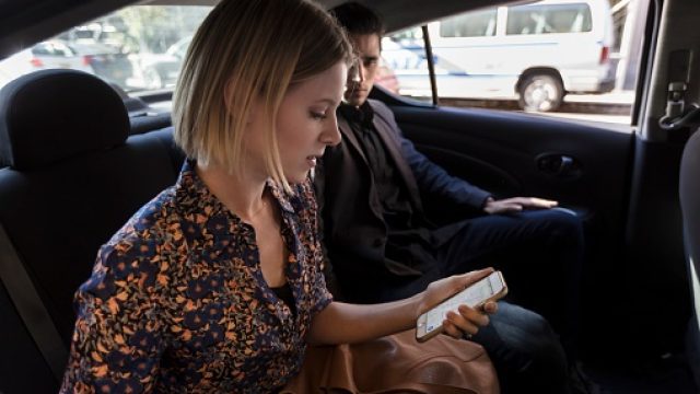Man and woman sitting in Uber or Lyft