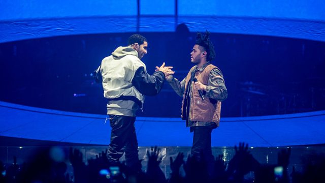Drake and the Weeknd perform together onstage.