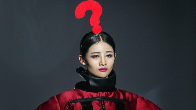 A model wears a giant question mark on her head on the runway during Wuhan Fashion Art Festival in China.