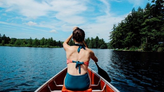 Woman kayaking in a bathing suit