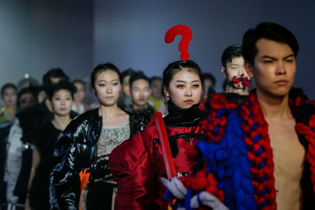 A model walked down the runway with a giant question mark on her head ...