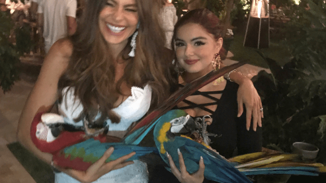 Sofia Vergara and Ariel Winter holding parrots at Memorial Day Party.