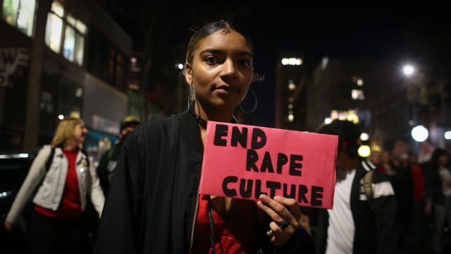 OAKLAND, CA - MARCH 8: A woman holds a sign reading "End Rape Culture" during a march for International Women's Day on March 8, 2017 in Oakland, California. Protest marches across the country attracted thousands of people who demanded an end to gender inequality. (Photo by Elijah Nouvelage/Getty Images)