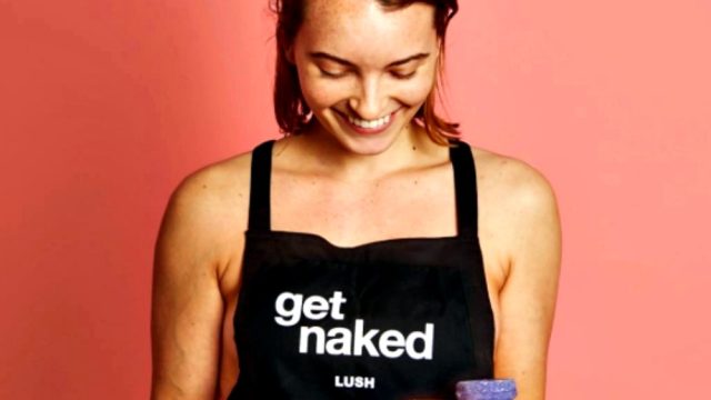 Lush employee holding tray of naked soaps.